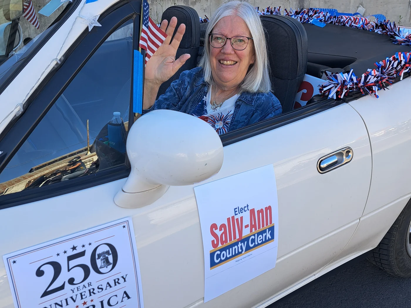 Sally-Ann greeting voters from a campaign car